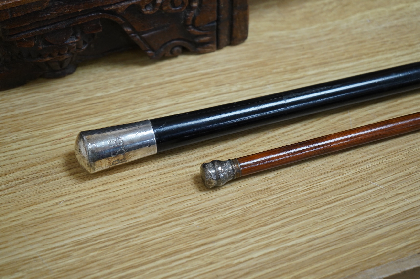 Two silver topped walking canes, largest 94cm in length